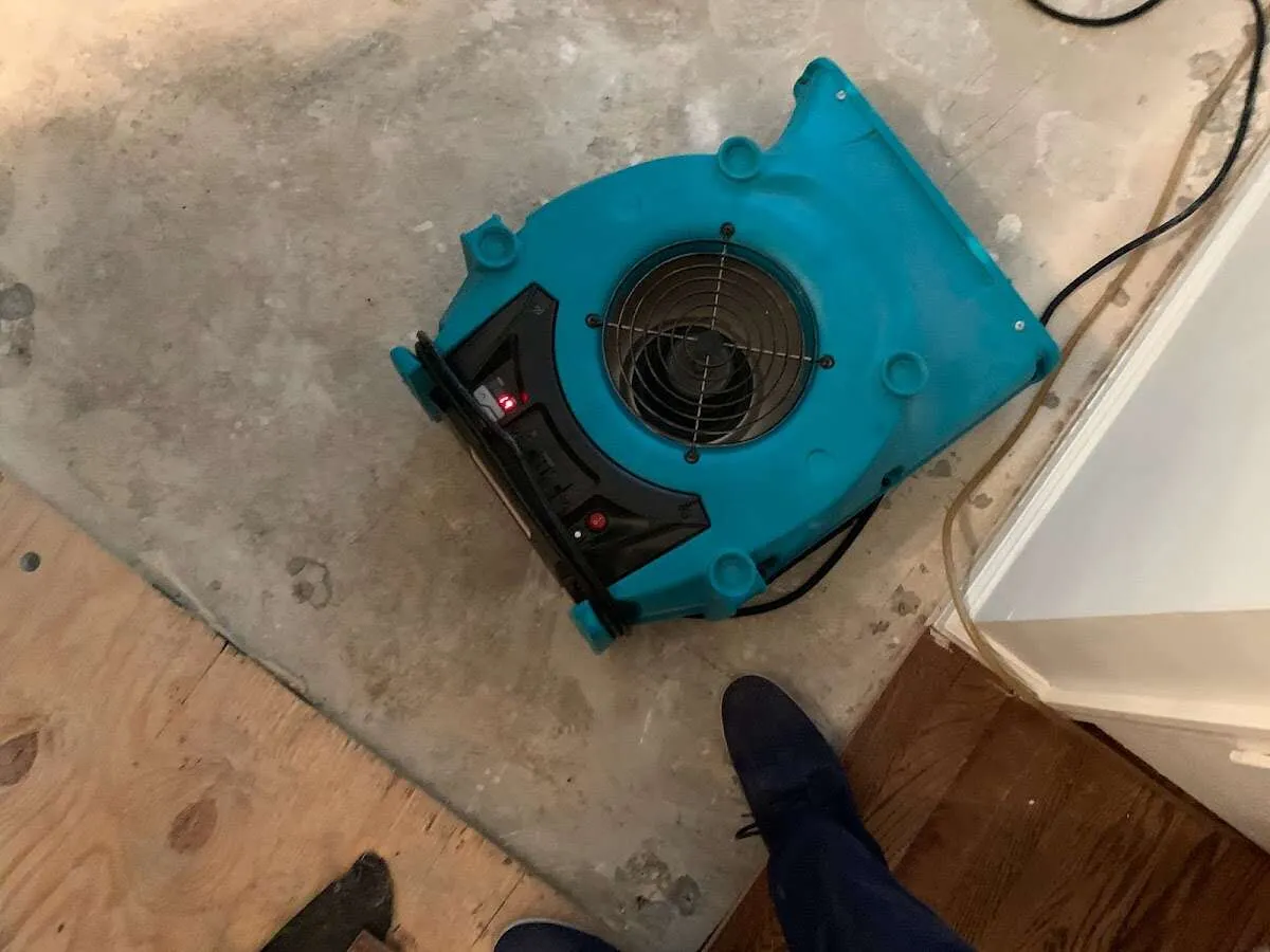 Air mover drying subfloor during Commercial Water Damage Restoration in Onalaska